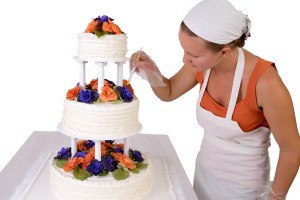 Final Touch Ups On Ruffled Wedding Cake