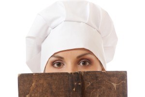 woman cook reading recipes book, isolated on white