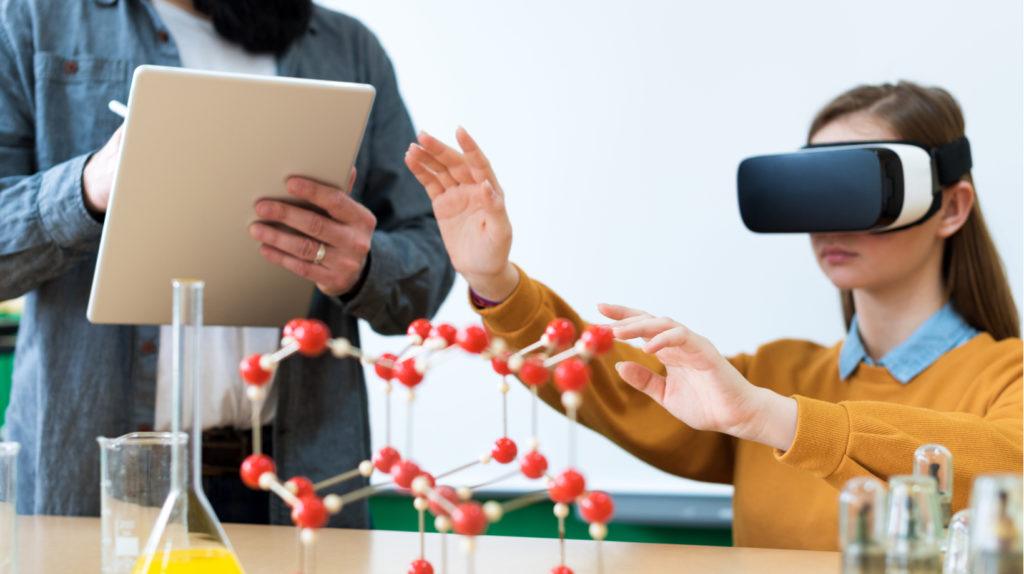 A girl sitting in a chair wearing VR glasses is doing a test of glass, and on the other side, a man is standing and writing her performance on a notepad