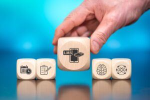 Wooden,Blocks,With,Symbol,Of,Lms,Concept,On,Blue,Background