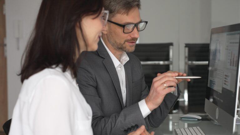 Business,Professionals,Collaborating,And,Discussing,Information,On,A,Computer,Screen