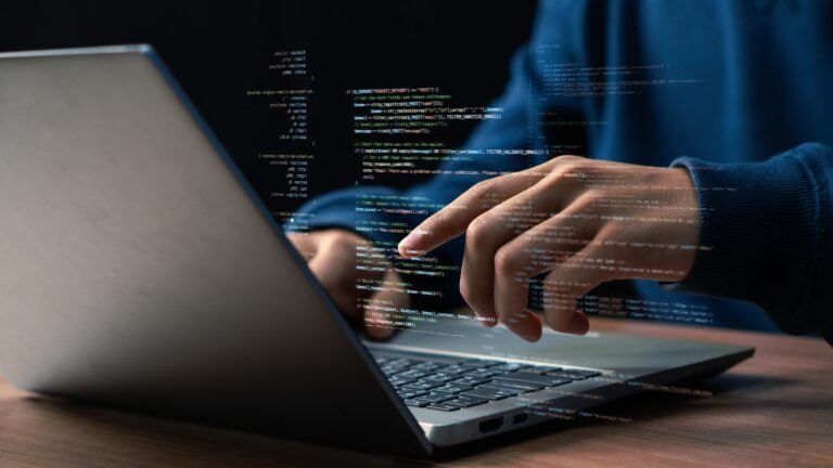 Software,Development,Concept.,Hands,Typing,On,Laptop,With,Programming,Code